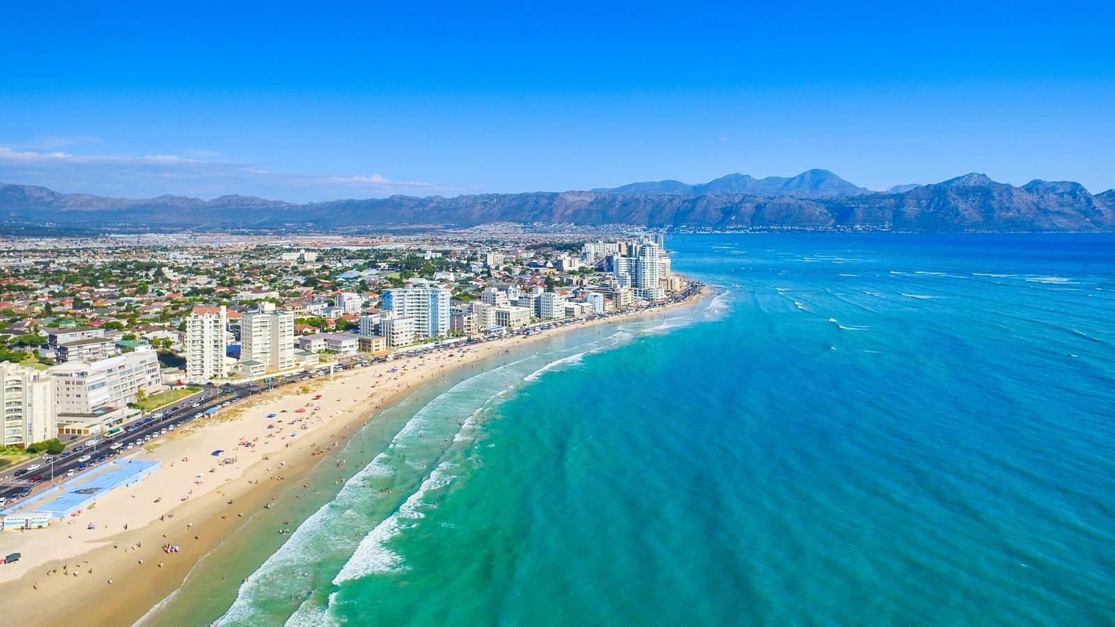 Strand from the air: the beach, Beach Road and the Hottentots Holland mountains behind the town