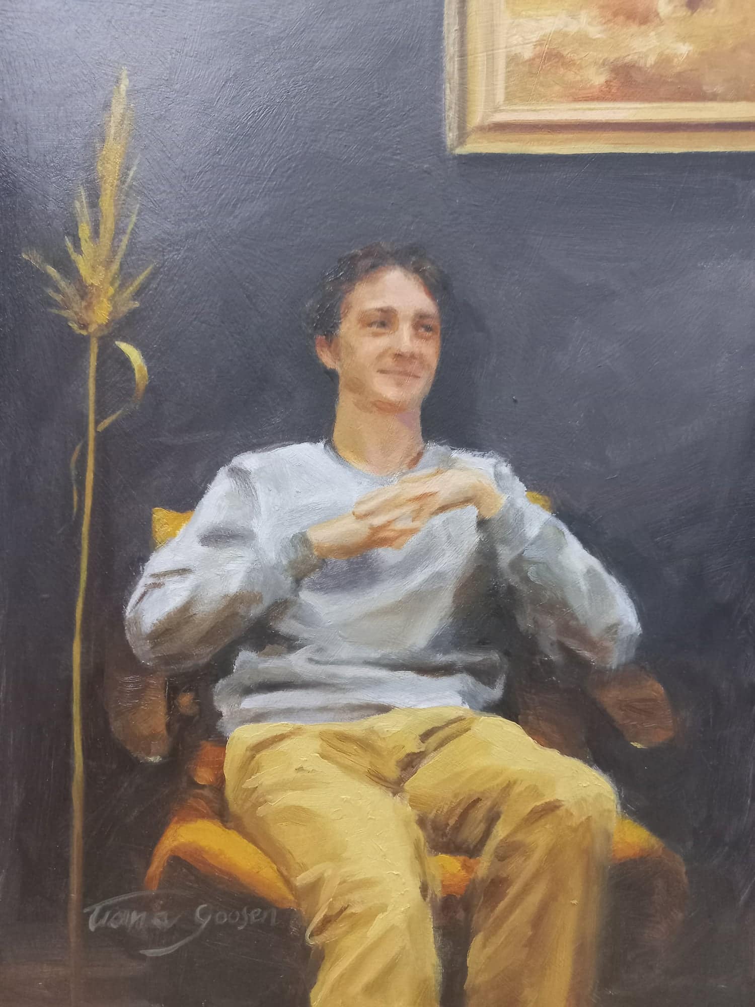 An oil portrait of a young man seated in a yellow chair, by Tiana Goosen